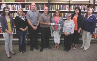 Members of the West Central Iowa Regional Board of REALTORS® recently presented a check for $1000 to the Carroll Library Foundation. The funds were provided by the REALTOR® Foundation of Iowa. Every year, the Iowa REALTOR® Foundation contributes thousands of dollars to affordable housing programs, scholarships for bright, young Iowans, and promotes other programs across the state that keep Iowa an attractive place to live. Pictured from left to right are: Carroll Public Library Director Rachel Van Erdewyk, REALTOR® Carrie Riesberg, REALTOR® Brandon Snyder, REALTOR® Mike Franey, REALTOR® Donna Pudenz, Marilyn Setzler of the Carroll Public Library Foundation, REALTOR® Holly Schreck, and Bev Schultes with the Carroll Public Library Foundation. (photo courtesy of the Daily Times Herald)